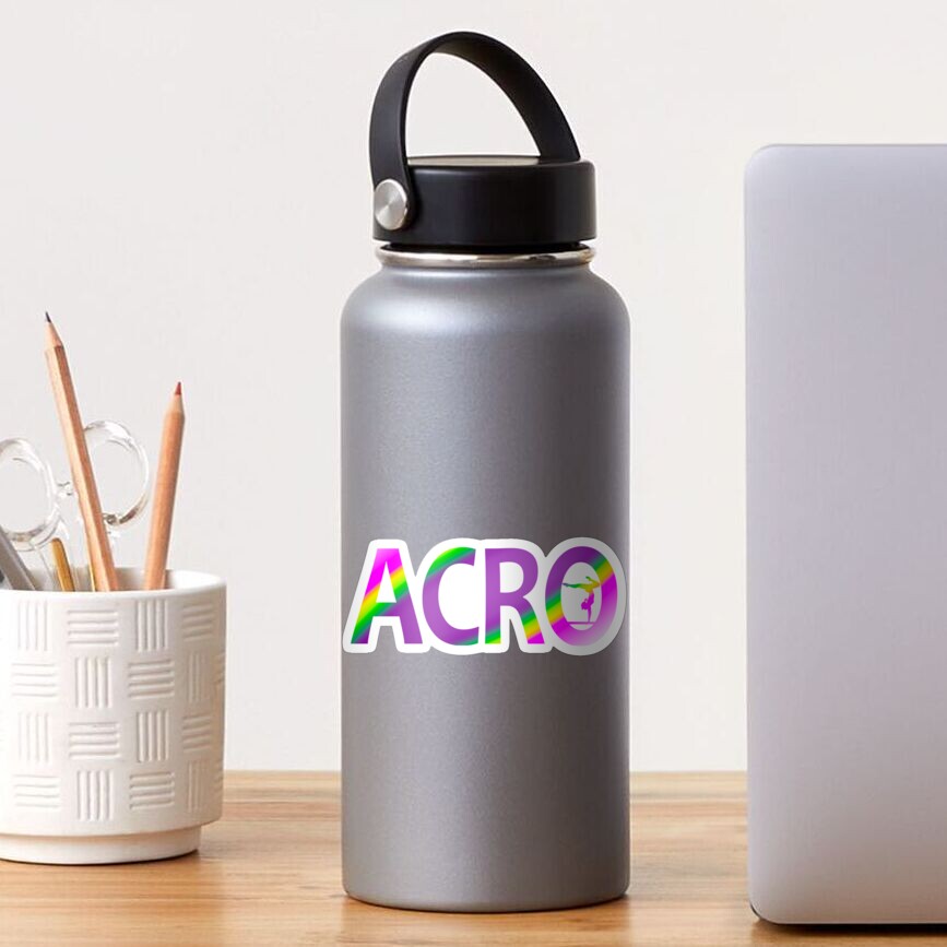 a desk with a silver tumbler with a rainbow "ACRO" sticker on it